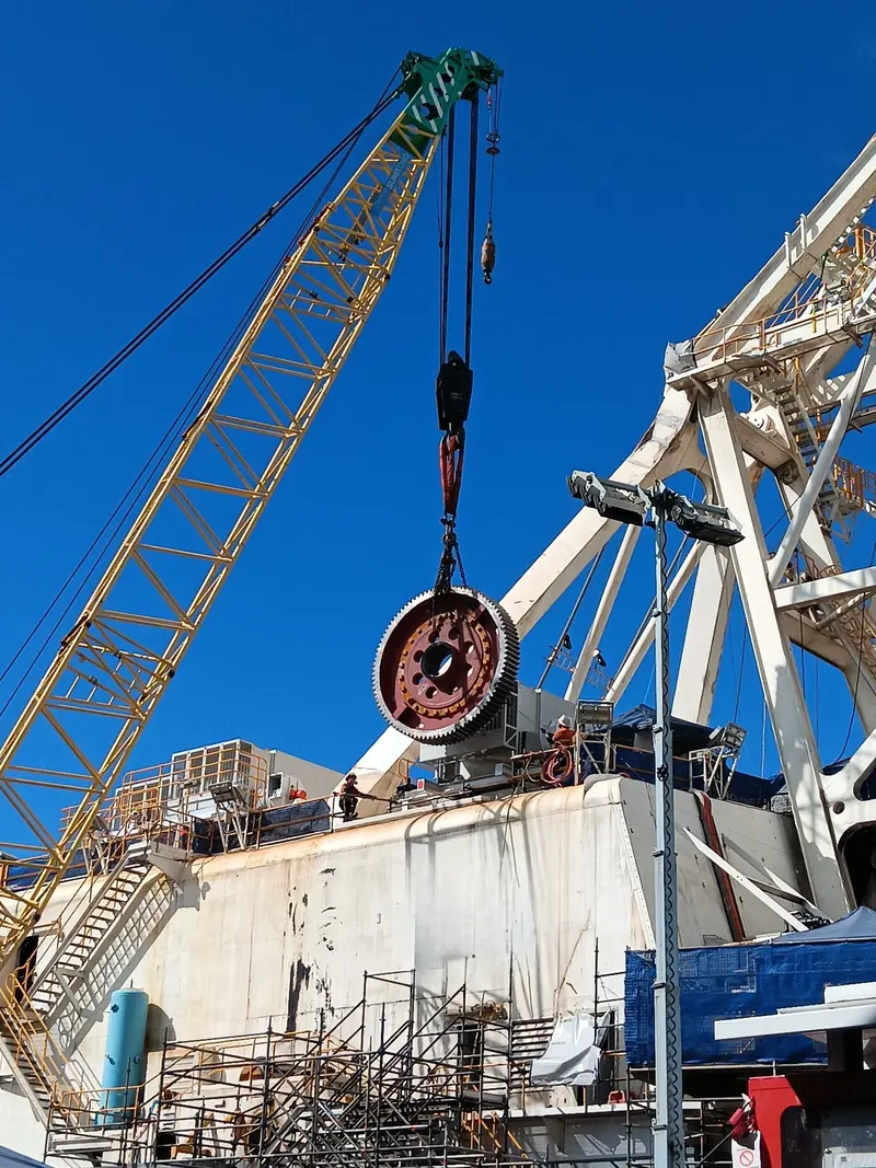 Large gear being lifted by crawler crane onto a dragline deck