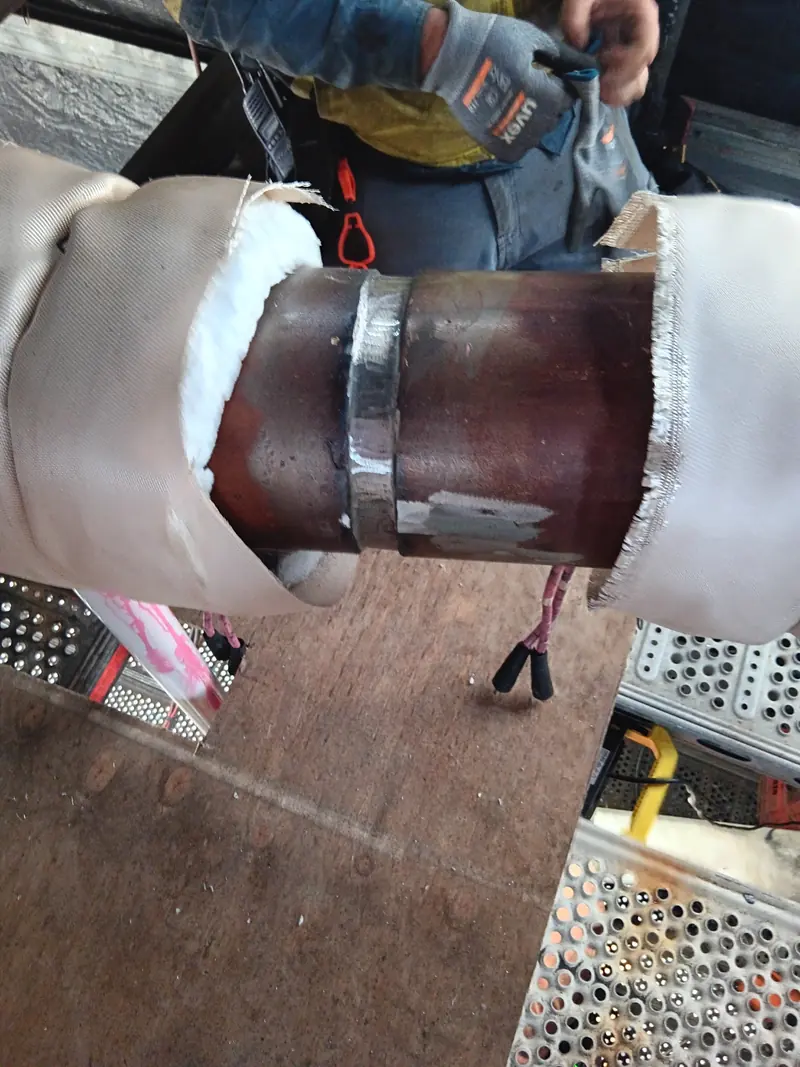 Completed boom lacing butt weld with heat-treatment blanket pulled back